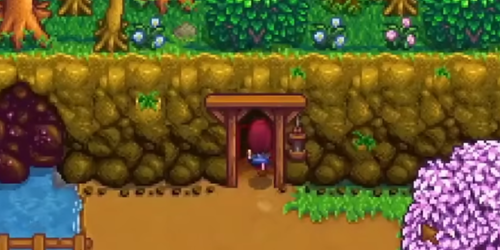Player entering the Mines entrance in Stardew Valley during Spring to begin early-game mining progression.